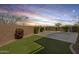 Spacious backyard featuring lush greenery and a convenient paddle tennis court for outdoor recreation at 890 W Zion Pl, Chandler, AZ 85248