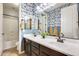 Bathroom with double sink vanity, modern fixtures, decorative wallpaper, and plenty of storage at 890 W Zion Pl, Chandler, AZ 85248