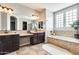 Beautiful bathroom featuring double vanities, soaking tub, and stylish tile work at 890 W Zion Pl, Chandler, AZ 85248