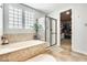 Serene bathroom featuring a soaking tub, glass-enclosed shower, and ample natural light at 890 W Zion Pl, Chandler, AZ 85248
