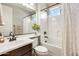 Bright bathroom with a combination tub and shower, dark wood cabinet, and white tile at 890 W Zion Pl, Chandler, AZ 85248