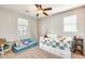 Bright bedroom featuring a ceiling fan, daybed with storage, and a cozy seating area with natural light at 890 W Zion Pl, Chandler, AZ 85248