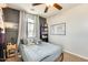 Comfortable bedroom with a bookshelf, gray accent wall, a map, and lots of natural light at 890 W Zion Pl, Chandler, AZ 85248
