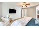 Comfortable bedroom with a ceiling fan, mounted TV, and a cozy sitting area at 890 W Zion Pl, Chandler, AZ 85248