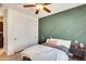 Cozy bedroom featuring a decorative green accent wall, ceiling fan, and closet at 890 W Zion Pl, Chandler, AZ 85248