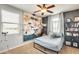 Modern bedroom with a pegboard wall feature, comfortable bed, neutral color palette, and ample natural light at 890 W Zion Pl, Chandler, AZ 85248