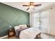 Stylish bedroom features an accent wall, a cozy bed, bedside tables, and natural light at 890 W Zion Pl, Chandler, AZ 85248