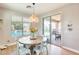 Dining area features a round table with modern seating, natural light, and views of the outdoor pool at 890 W Zion Pl, Chandler, AZ 85248