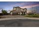 Inviting two-story home with a two-car garage, desert landscaping, and a charming tile roof at 890 W Zion Pl, Chandler, AZ 85248