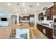 Gourmet kitchen features stainless steel appliances, granite countertops, dark cabinets, and a large island at 890 W Zion Pl, Chandler, AZ 85248