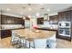 Modern kitchen features a large center island, dark wood cabinetry, and stainless steel appliances at 890 W Zion Pl, Chandler, AZ 85248