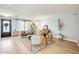 Airy living area with a leather couch, light hardwood floors, and an accent wall with built in shelves at 890 W Zion Pl, Chandler, AZ 85248