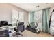 Functional office with a large window, desk and chair, along with exercise equipment at 890 W Zion Pl, Chandler, AZ 85248