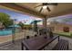 Covered patio with dining set overlooking a pool and backyard entertainment area, ideal for outdoor gatherings at 890 W Zion Pl, Chandler, AZ 85248