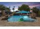 Resort-style pool with a rock waterfall, tropical landscaping, and an inviting atmosphere at 890 W Zion Pl, Chandler, AZ 85248