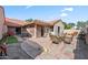 Well-maintained backyard featuring a patio with dining set, grill, and access to multiple entry points at 945 N Pasadena -- # 35, Mesa, AZ 85201