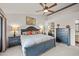 This is a bedroom with a ceiling fan, a decorative wall and a wall of mirrors at 945 N Pasadena -- # 35, Mesa, AZ 85201