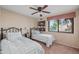 Cozy bedroom with two beds, decorative wallpaper and a ceiling fan at 945 N Pasadena -- # 35, Mesa, AZ 85201