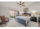 Bright bedroom with a ceiling fan, sliding glass door, and stylish furniture arrangement at 945 N Pasadena -- # 35, Mesa, AZ 85201