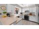 Bright kitchen featuring white cabinetry, neutral countertops and tiled floors at 945 N Pasadena -- # 35, Mesa, AZ 85201