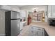 Bright kitchen with white cabinets, stainless steel appliances, and tile flooring at 945 N Pasadena -- # 35, Mesa, AZ 85201