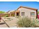 Exterior shot of the home's stucco facade, covered patio, and desert landscaping in the backyard at 10351 E Morning Star Dr, Scottsdale, AZ 85255