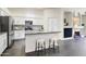 Open kitchen featuring white cabinets, modern appliances, and bar stool seating at 10351 E Morning Star Dr, Scottsdale, AZ 85255