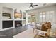 Bright living room featuring a fireplace, ceiling fan, and sliding door access to the backyard at 10351 E Morning Star Dr, Scottsdale, AZ 85255