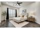 Inviting bedroom featuring a ceiling fan, large window, and minimalist decor at 10351 E Morning Star Dr, Scottsdale, AZ 85255