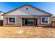 The back of the home features a covered patio and an expansive, empty backyard at 11660 W Luxton Ln, Avondale, AZ 85323