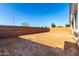 The large backyard is currently landscaped with dirt and enclosed by a block wall at 11660 W Luxton Ln, Avondale, AZ 85323