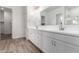 Modern bathroom featuring a double sink vanity, stylish fixtures, and wood-look tile flooring at 11660 W Luxton Ln, Avondale, AZ 85323