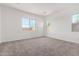 Light-filled bedroom with carpet flooring, neutral paint, and large windows offering natural light at 11660 W Luxton Ln, Avondale, AZ 85323