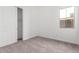 Bright bedroom with closet, window, and neutral carpeting, perfect for relaxation at 11660 W Luxton Ln, Avondale, AZ 85323