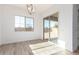 Light-filled dining area with wood-style tile flooring, backyard access, and modern chandelier at 11660 W Luxton Ln, Avondale, AZ 85323