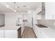 Modern kitchen featuring white cabinetry, stainless steel appliances, and a large center island at 11660 W Luxton Ln, Avondale, AZ 85323
