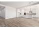 Open-concept living room featuring tile floors, a modern kitchen, and ample natural light at 11660 W Luxton Ln, Avondale, AZ 85323