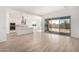 Open-concept living room featuring tile floors, a modern kitchen, and sliding glass door to backyard at 11660 W Luxton Ln, Avondale, AZ 85323
