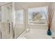 Bright bathroom featuring soaking tub under window and glass shower enclosure at 12425 W Jefferson St, Avondale, AZ 85323