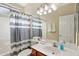 Neutral bathroom features extended vanity, mirrored wall, and shower-tub combo at 12425 W Jefferson St, Avondale, AZ 85323