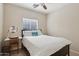 Bright bedroom features neutral walls, ceiling fan, and full-sized bed at 12425 W Jefferson St, Avondale, AZ 85323