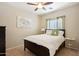 Well-lit bedroom features neutral walls, ceiling fan, and full-sized bed at 12425 W Jefferson St, Avondale, AZ 85323