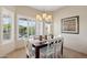 Bright dining room with a modern chandelier and views of the greenery at 12425 W Jefferson St, Avondale, AZ 85323