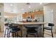 Well-lit kitchen with stainless steel appliances, granite countertops, and a breakfast bar at 12425 W Jefferson St, Avondale, AZ 85323
