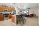 Open kitchen with stainless steel appliances and breakfast bar, flowing into the living area at 12425 W Jefferson St, Avondale, AZ 85323