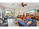 Comfortable living room with tile floors, modern furnishings, and access to the patio at 12425 W Jefferson St, Avondale, AZ 85323