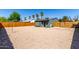 Gravel backyard with a shed, wood fence, and mature trees creates a private outdoor space at 1424 S Bonarden Ln, Tempe, AZ 85281