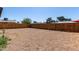 Large, low maintenance backyard features a gravel ground cover and wood fence at 1424 S Bonarden Ln, Tempe, AZ 85281