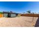 Spacious backyard with detached shed, gravel, and wood fence is ready for customization at 1424 S Bonarden Ln, Tempe, AZ 85281