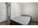 Bedroom with wood look floors and a door that leads to an ensuite bathroom at 1424 S Bonarden Ln, Tempe, AZ 85281